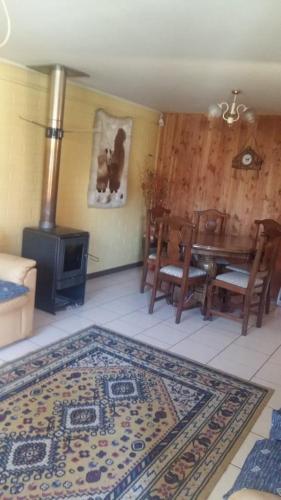 a dining room with a table and a wood stove at casa 936 in Pucón