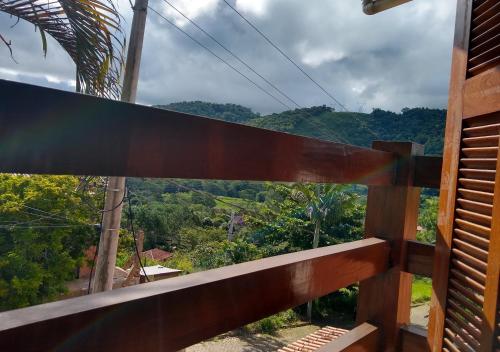 a wooden balcony with a view of a mountain at Pousada Castelinho Conservatória in Conservatória