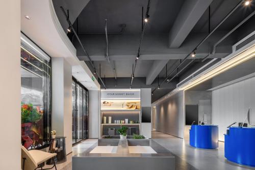 a lobby of a building with a table and chairs at Atour Light Hotel Zhoushan Dinghai South Renmin Road in Zhoushan