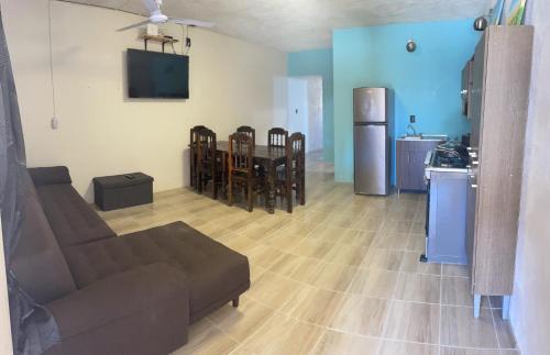 a living room with a couch and a kitchen at CASA RAQUEL in Rincon de Guayabitos