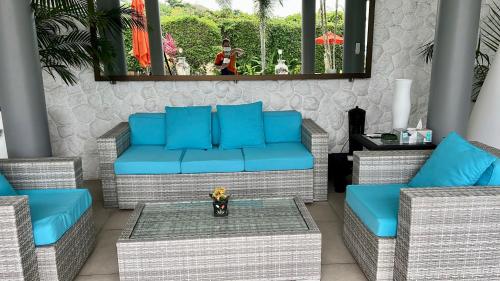 a living room with a blue couch and chairs at Villa Tropical Cocoon in Koh Samui 