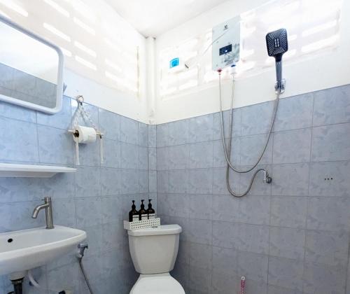 a bathroom with a shower and a toilet and a sink at Neverland Beach Village Bungalows in Ko Lanta