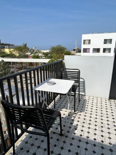 a table and two chairs sitting on a balcony at 琉球鳥巢旅店 in Xiaoliuqiu