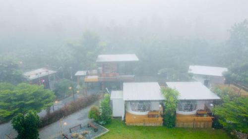a house in the rain with a foggy at Heaven Hill Camping in Ban Thung Na