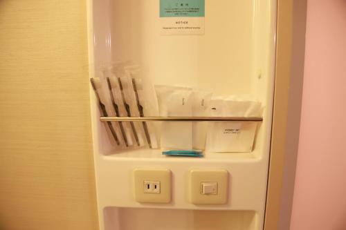a white refrigerator with two chairs inside of it at Naeba Prince Hotel in Yuzawa