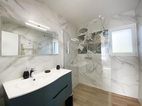 uma casa de banho branca com um lavatório e um chuveiro em Maison Sarzeau, 5 pièces, 6 personnes - FR-1-639-103 em Sarzeau