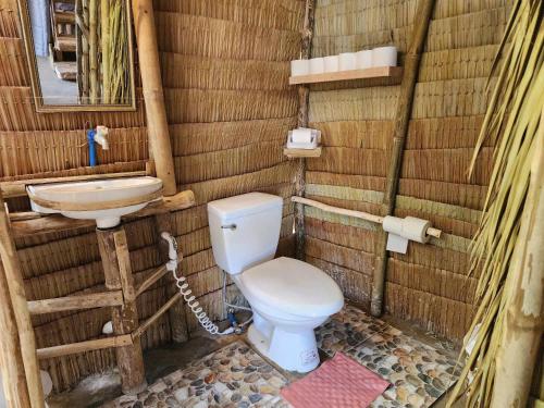 a bathroom with a toilet and a sink at BICE Camp Bucana Beach in El Nido