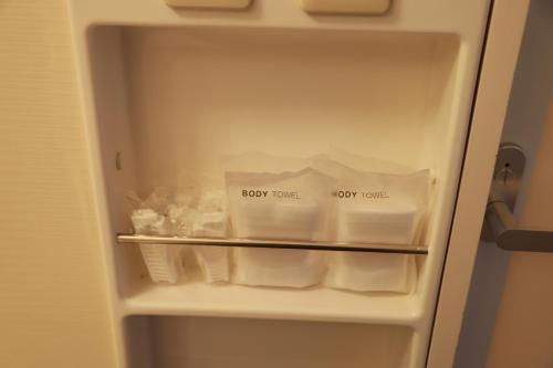 an open refrigerator filled with lots of food items at Naeba Prince Hotel in Yuzawa