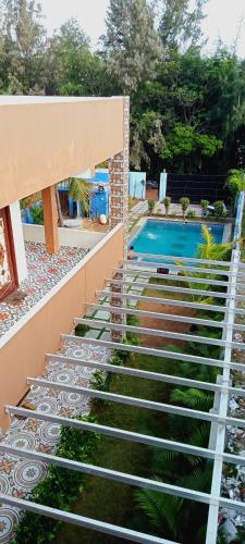 a set of stairs leading to a swimming pool at Le Grace Kovalam in Chennai