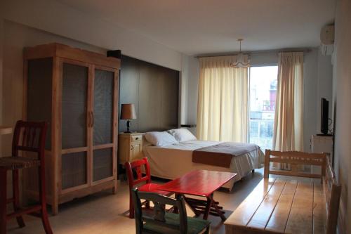 En eller flere senge i et værelse på Miliño Apart Hotel