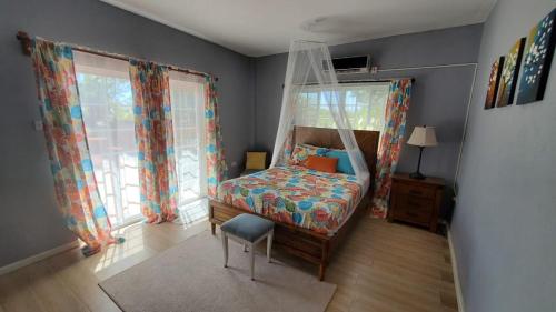 a bedroom with a bed with a mosquito net at NATURES BLISS-ISLANDERS in Choiseul