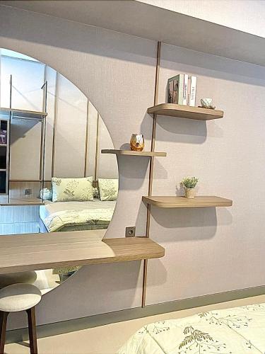 a room with shelves and a bed and a mirror at 2 BR I ANDERSON I 22floor I above pakuwon mall I the biggest shopping center in Surabaya