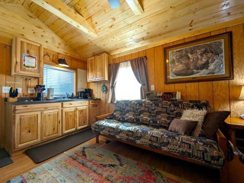a living room with a couch in a cabin at Yellowstone's Treasure Cabins in Gardiner