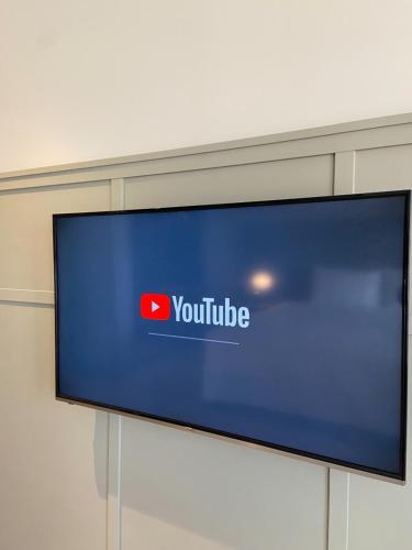 a television with a youtube sign on a wall at Greet Inn in Kaohsiung
