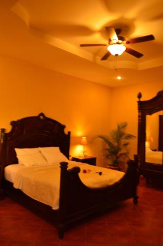 um quarto com uma cama e uma ventoinha de tecto em Hotel Real Leon em León