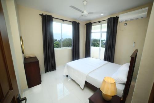 a bedroom with a bed and a large window at BNB RESIDENCIES MOUNT LAVINIA 2 in Mount Lavinia