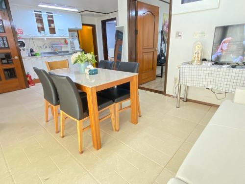 a dining table and chairs in a living room at Aroha house for Foreign guests only in Seoul