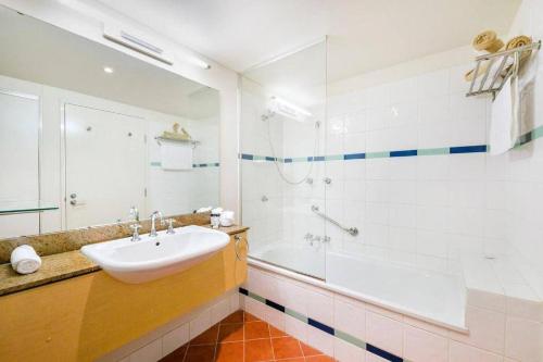 a bathroom with a sink and a shower at Elegant Harbourside Comfort with Alfresco Patio in Darwin