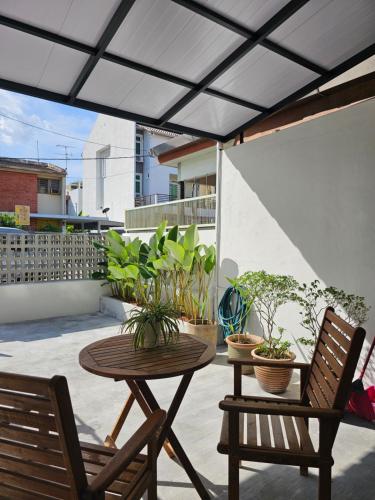 a patio with a table and chairs and plants at Summer Home 15 Georgetown Adventist in George Town