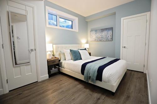 a bedroom with a bed with blue walls and wooden floors at Queen Bed,Near Airport,Kids Playground,Disney+ in Edmonton