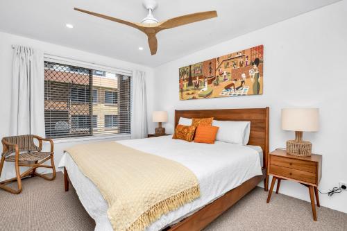 a bedroom with a large bed and a window at Lou's Tiki Pad in Gold Coast
