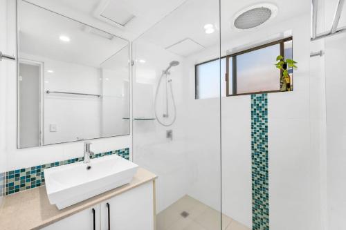a bathroom with a sink and a shower at Lou's Tiki Pad - Beachfront Bilinga North Kirra - Min. 2 Night Stays! in Gold Coast