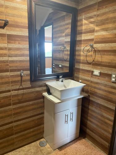 a bathroom with a sink and a mirror at Casa Sra Oti, Tipo Hostal con vista al mar Puerto Montt - CHINQUIHUE in Puerto Montt