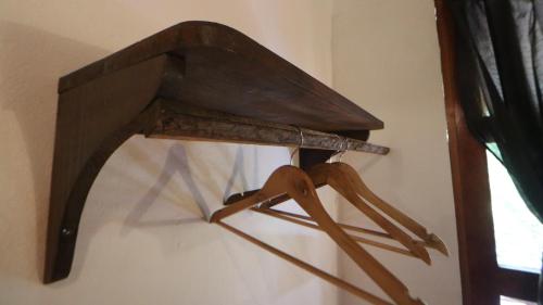 a wooden object hanging on a wall next to a window at Casa AVA in Mazunte