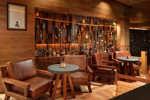 a restaurant with two tables and chairs and a bar at Presidente InterContinental Mexico City by IHG in Mexico City