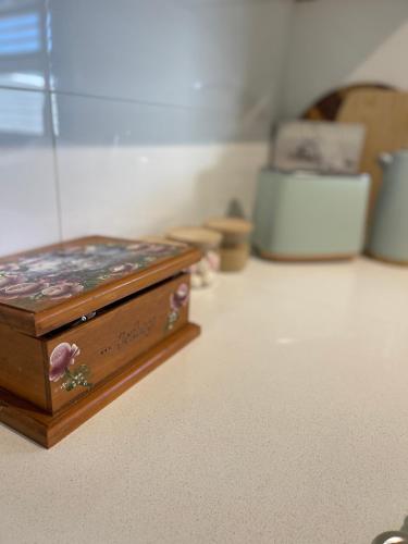 a wooden box sitting on the floor in a room at Charming & Cozy 2BR Cottage in Blacktown