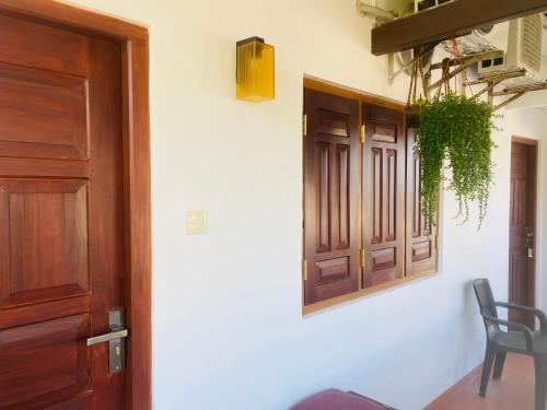 a room with a door and a chair and a window at Bienvenido Cozy Madiha in Matara
