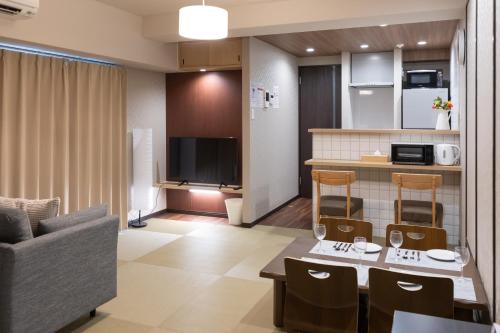 a small living room with a kitchen and a living room at 心斎橋-道頓堀の宿 ー南海難波徒歩10分以内 in Osaka
