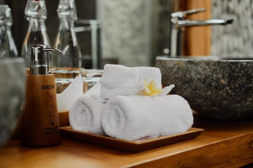 a pile of towels on a counter in a bathroom at Anandari Ubud Villa in Ubud