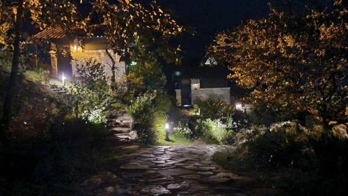 a stone path in front of a house at night at SAPA JADE HILL( CĂN CHỦ BIỆT THỰ) in Sa Pa