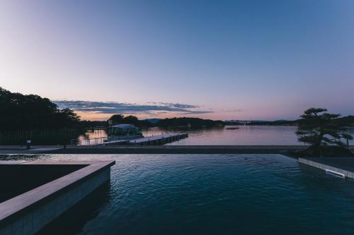 a large body of water with a tree in it at MOKU ISESHIMA ーl モク伊勢志摩 lー in Shima