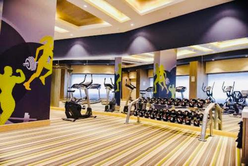 a gym with a bowling alley and a bowling ball mural at Hotel Migrolino in Lucknow