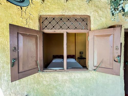 an open window of a room with a bed at Hotel La Felicita in Mirissa