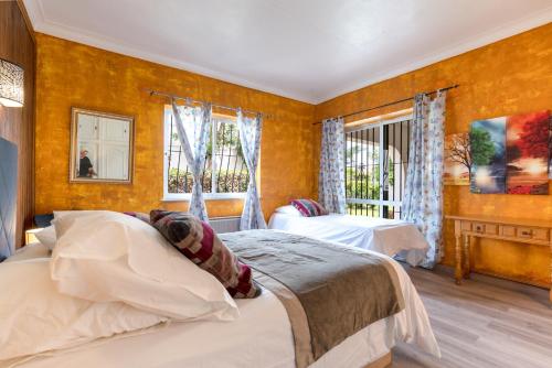 a bedroom with two beds and a window at Family villa with garden next to the beach in Mijas Costa