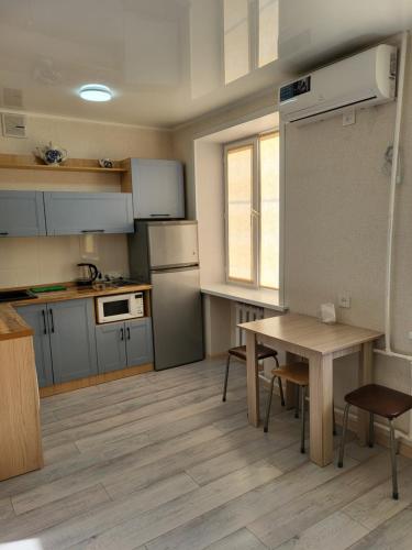 uma pequena cozinha com mesa e mesa em Квартира em Balkhash