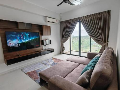 a living room with a couch and a flat screen tv at Sweet Home 暖居 Danga Bay CountryGarden in Johor Bahru