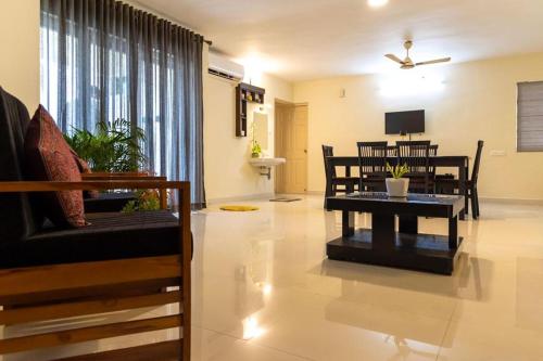 a living room with a couch and a table at BEST SERVICED APARTMENT IN COCHIN,MARINE DRIVE in Cochin