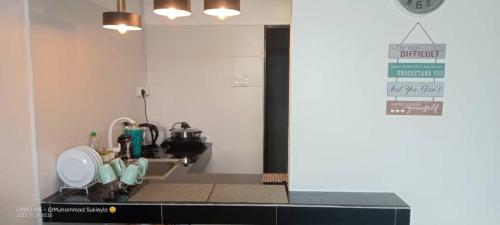 a kitchen with a sink and a counter top at RJ STUDIO 2- Kompleks Mutiara in Gua Musang