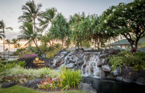 a waterfall in the front yard of a resort at Ko Olina Beach Villas O704 in Kapolei
