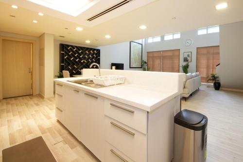 a kitchen with a sink and a living room at New Arabian Loft Central Downtown in Dubai