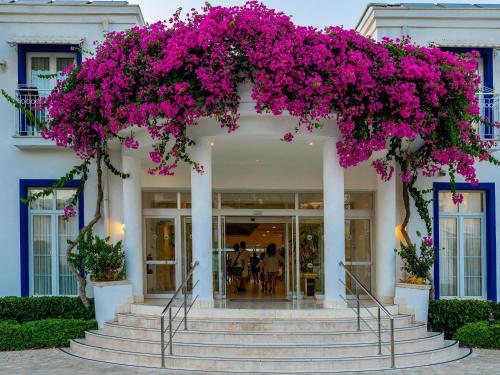 a wreath of pink flowers on a white building at Labranda TMT Bodrum in Bodrum City