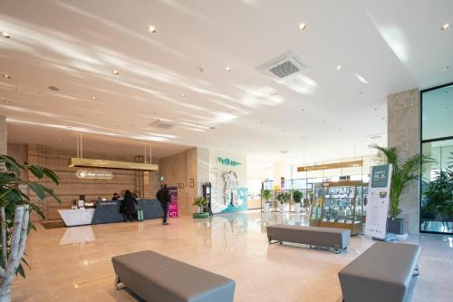 a lobby of a store with two benches in it at Gangjin K-Stay Tourist Hotel in Gangjin