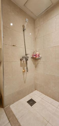 a shower with a shower head in a bathroom at Mizo Hotel in Seoul