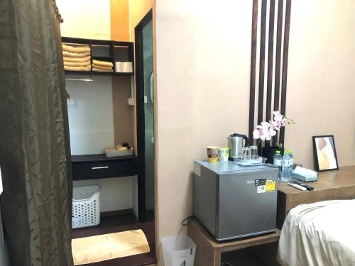 a room with a small refrigerator in a bedroom at nine guesthouse in Ban Pa Tung (7)