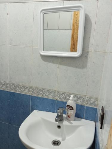 a bathroom with a sink and a mirror on the wall at Appart Bab Alandalous in Tangier