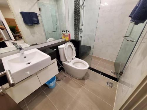 a bathroom with a toilet and a sink and a shower at Supalai Bangkok in Bangkok